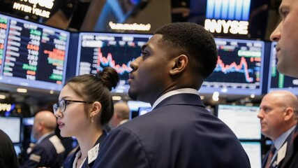 Focused financial traders analyzing market trends on trading floor - Stock traders watching market monitors - Powered by Adobe