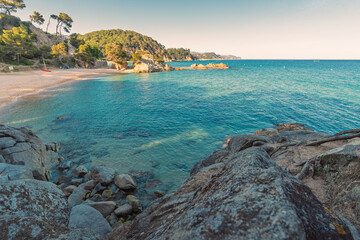 A quiet little bay with a beach of Cala Treumal with fine golden sand sheltered by rocky cliffs and...