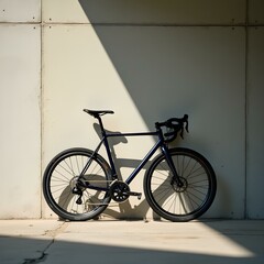 Sleek Dark Blue Gravel Bike Leaning Against a Wall in Sunlight