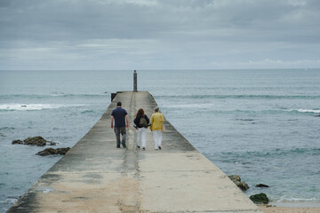 A family walks on a jetty 