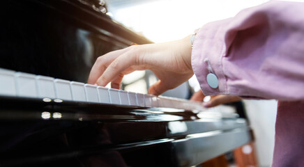 Close up of woman hands playing piano