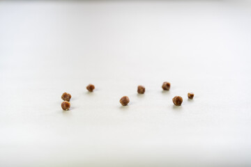 8 brown gallbladder lumps or gallstones from cholesterol or bad food on gray white table for medical background isolated with copy space