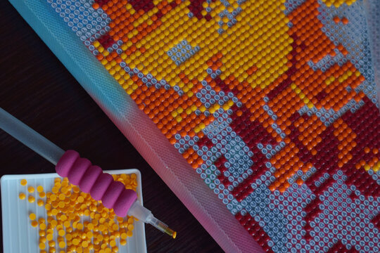 Detailed colorful diamond painting closeup showing vibrant beads and tools perfect for DIY hobby crafting handmade artistic projects and creative design concepts