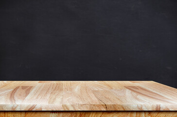 Empty wooden table with copy space on school table with black board in background