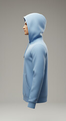 Side view of a man wearing a light blue hoodie with the hood up, against a neutral background.