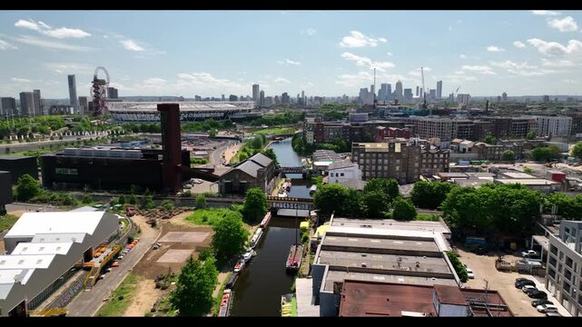 Residential town and water canal Olympic stadium in the background in the large city, Crane down shot, London UK