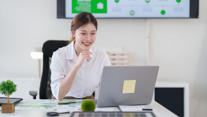 Young Asian Woman Working On Green Business Strategy For Corporate Sustainability Promoting Environmental Social Governance