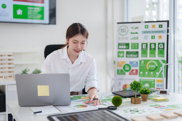 Asian Adult Woman Working on ESG Green Business Strategy Reducing Carbon Dioxide Emissions Sustainable Renewable Energy Project Planning