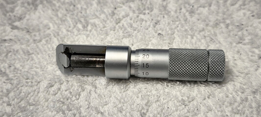 Micrometer for measuring thickness placed on a white towel