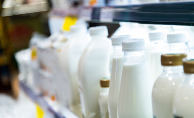 Milk bottles on the supermarket shelf