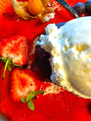 strawberry and vanilla ice cream with fresh berries, close up