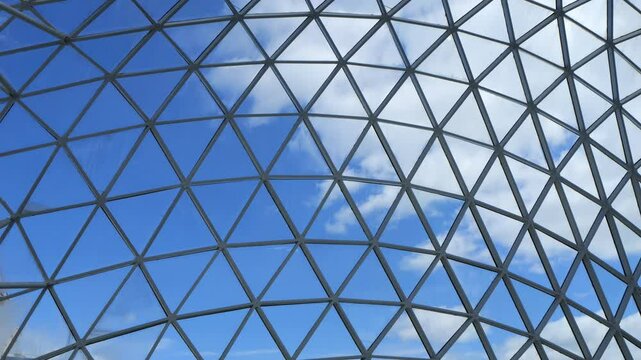 Large, clear dome with a blue sky and a few clouds. The dome is made of glass and has a triangular shape