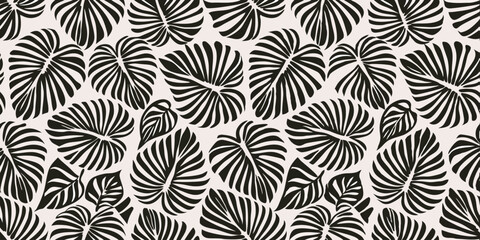 Black and White Monstera Leaves Pattern: A stylish seamless pattern featuring black and white illustrations of monstera deliciosa leaves. © Rahimatul