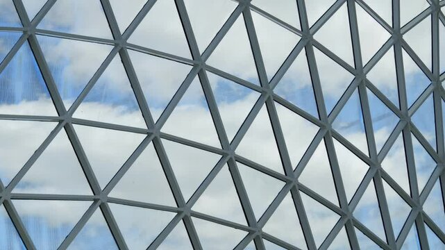 Large, intricate design made up of many small triangles. The design is made of metal and he is a part of a building or structure. Scene is one of complexity and sophistication