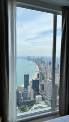 Cityscape view of Chicago skyline from hotel window overlooking lake  