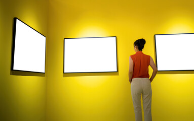 Woman standing and looking blank pictures