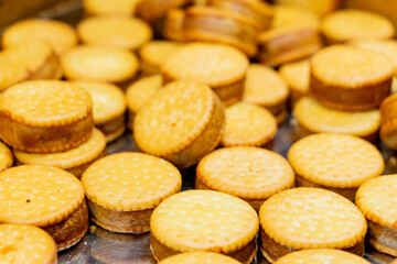 A scenic nighttime view of colorful round lanterns adorning the bridge piers above the water. The reflections shimmer on the calm surface, creating a magical and festive atmosphere that celebrates tra