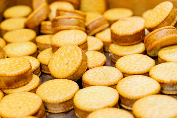 A scenic nighttime view of colorful round lanterns adorning the bridge piers above the water. The reflections shimmer on the calm surface, creating a magical and festive atmosphere that celebrates tra