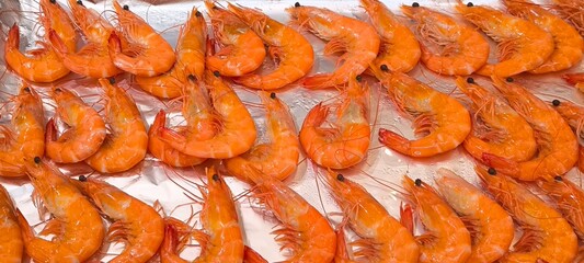 Orange boiled shrimp on a silver tray in a restaurant