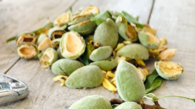 Shelled Almonds and Almond Shells on Rustic Wooden Table, Natural Concept.
