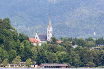 A picturesque view across the serene waters of Lake Bled, showcasing the charming town of Bled...