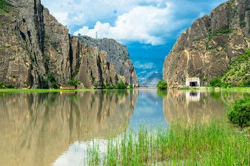 Dramatic landscape of a picturesque cliff gorge on a mountain river in pre-storm weather on the...