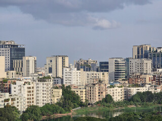 Fototapeta premium Dhaka city skyline with modern buildings and clear blue sky, urban architecture and cityscape view of Bangladesh capital. High angle view of Dhaka city residential and financial buildings at sunny day
