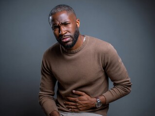 Man with Stomach Ache: A portrait of a man holding his stomach, displaying discomfort and pain.  His expression conveys unease and physical distress.