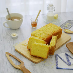 Slice of sponge cake with cheese flavor on the wooden table