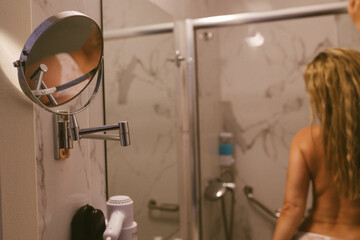 Woman in bathroom with wet slim sexy body taking a shower