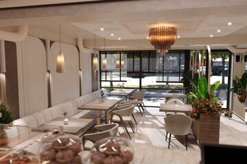 modern cafe seating with wooden tables, soft lighting, and elegant decor