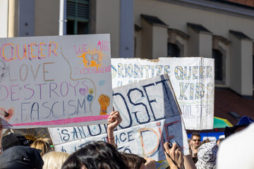 Colorful protest signs advocating for LGBTQ rights and social justice