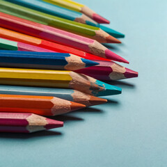 Fototapeta premium Vector art of closeup of colorful pencils on a blue background