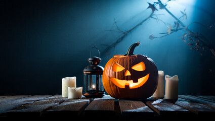 Carved Halloween Pumpkin Lantern Candles and Black Lantern on Wooden Table