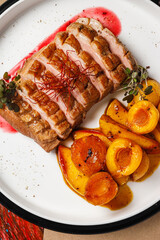 Deliciously plated roast duck with glazed fruits