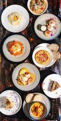 Delicious variety of gourmet dishes on rustic wooden table