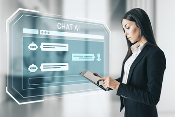 Businesswoman interacting with futuristic chat AI interface using tablet in modern digital workspace environment.