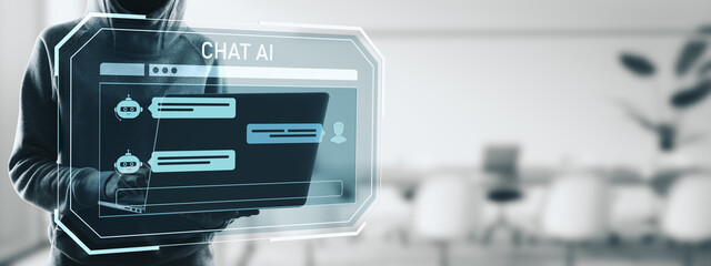 Person using laptop with chat AI interface displayed as holographic screen in modern digital office...