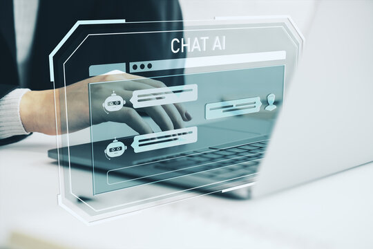 Person using laptop with holographic chatbot interface representing AI-powered communication and virtual assistant technology in modern workspace.