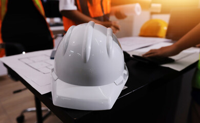 Closeup of team of industrial engineers meeting analyze machinery blueprints consult project on...