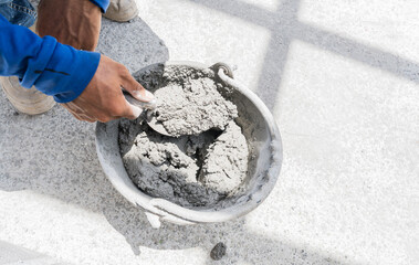 Hand worker with trowel wet Cement bucket for Masonry brick wall, Concrete Mix