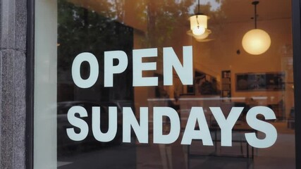 Open Sundays sign in a store.