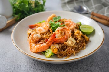 Stir-fried Thin Rice Noodles with dark Soy Sauce and shrimp in ceramic plate,