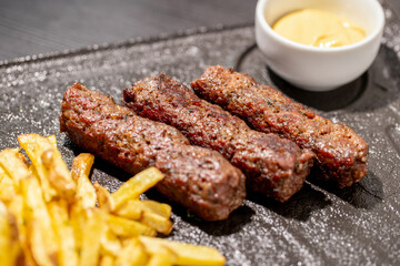 details of tasty romanian mici with fries