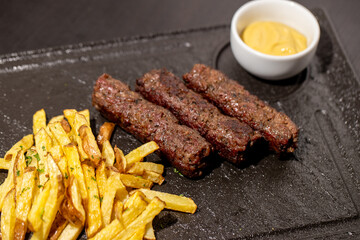 details of tasty romanian mici with fries