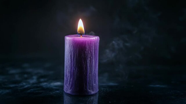 Purple candle burning on dark background with copy space