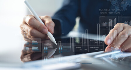 Obraz na płótnie Canvas Finance analyst working on business analytics and data management system to make financial report with business performance, KPI dashboard. Corporate strategy for finance, digital marketing plan