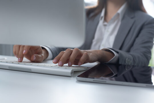 Business woman working on computer at desk in office for online research, reading email or report. Female entrepreneur person with internet connection, typing on computer keyboard, closeup - Powered by Adobe