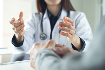 Female doctor explaining to male patient about checkup result, medical screening, giving...