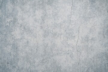 Aged concrete wall with blue and grey stains featuring cracks and a vintage appearance
